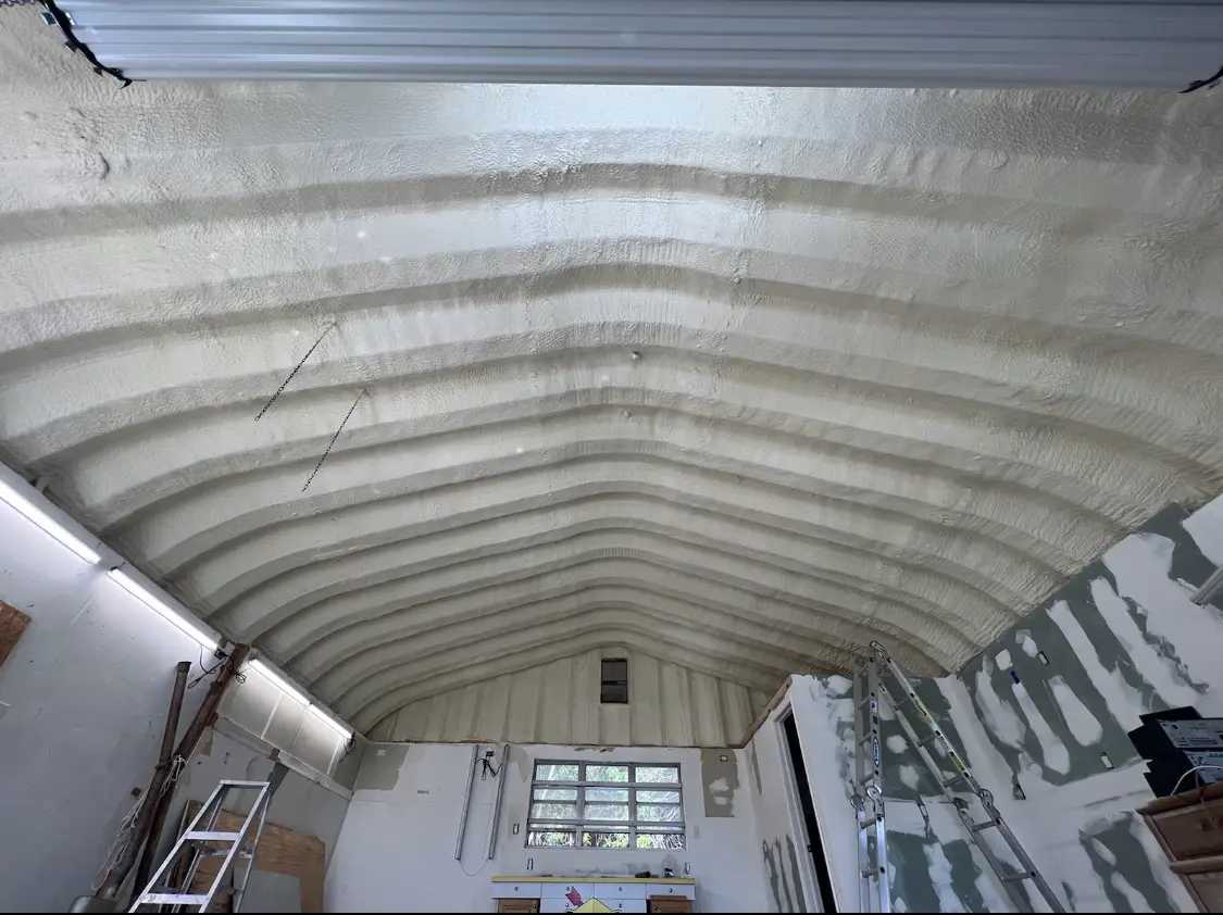 Spray polyurethane foam applied to the underside of a metal roof deck in Denville